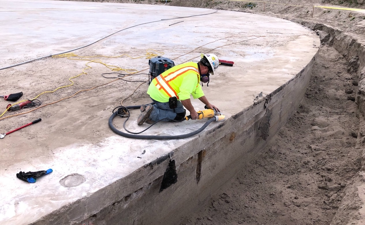 Construction worker sanding a joint