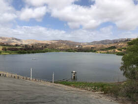 Reservoir full of water surrounded by landscape